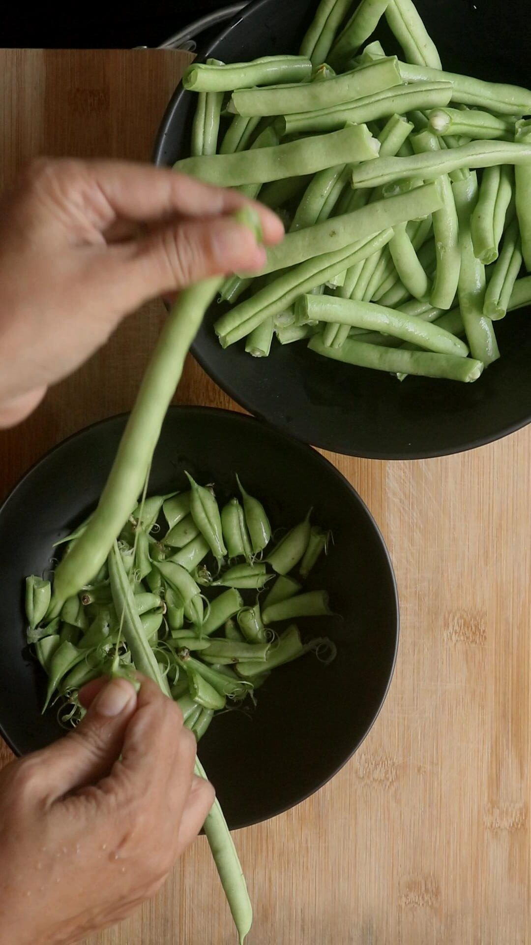 remove strings from the beans and pinch the ends.