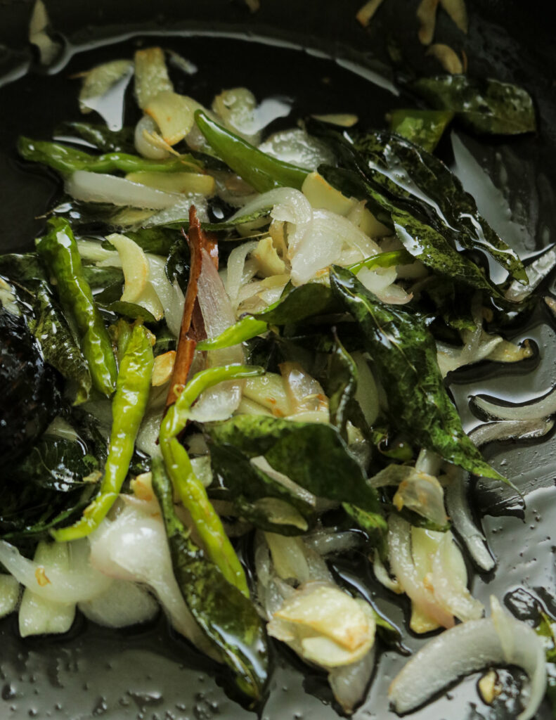 tempered onions, garlic, green chillies to make the egg curry.