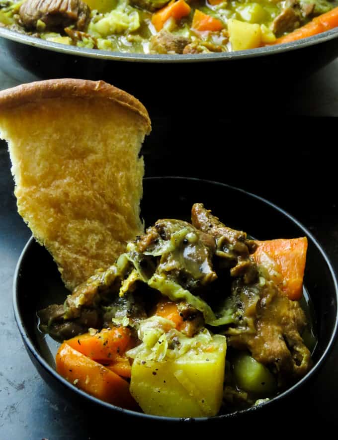 Peppery beef stew with cabbage and bread to eat it.