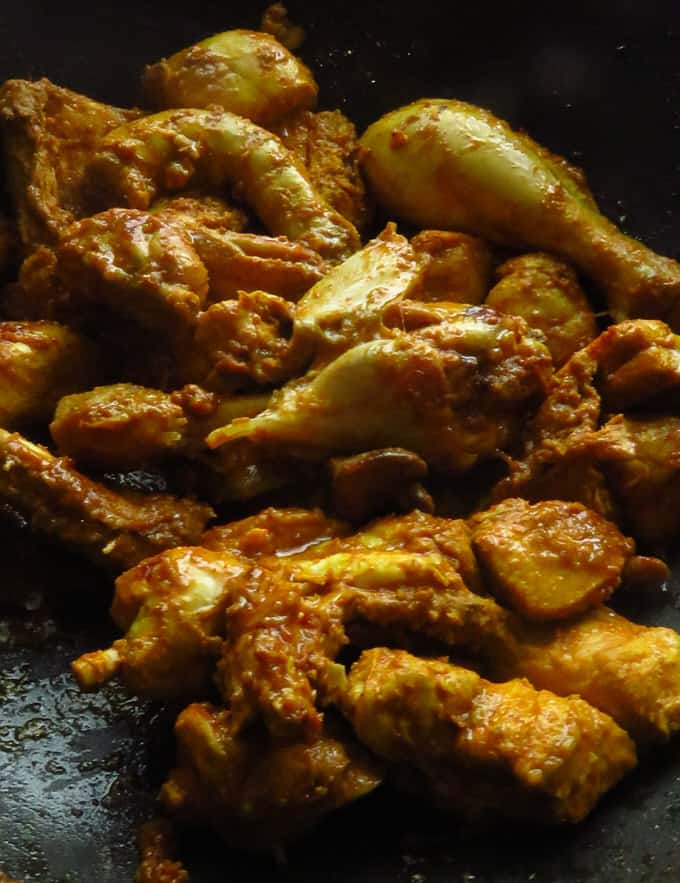 cooking the chicken pieces to make the mughlai chicken.