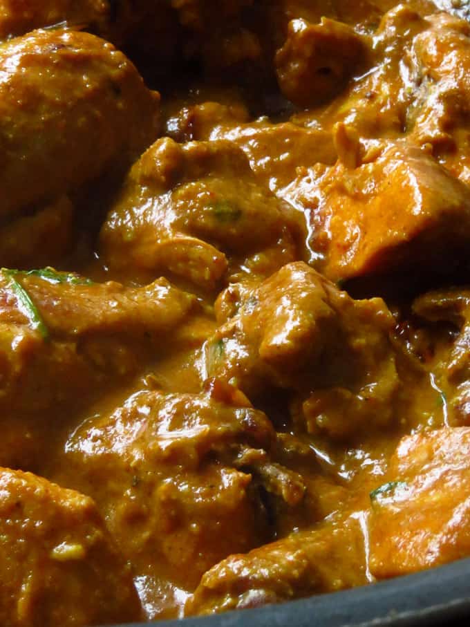 thick mughlai chicken curry covered in gray.