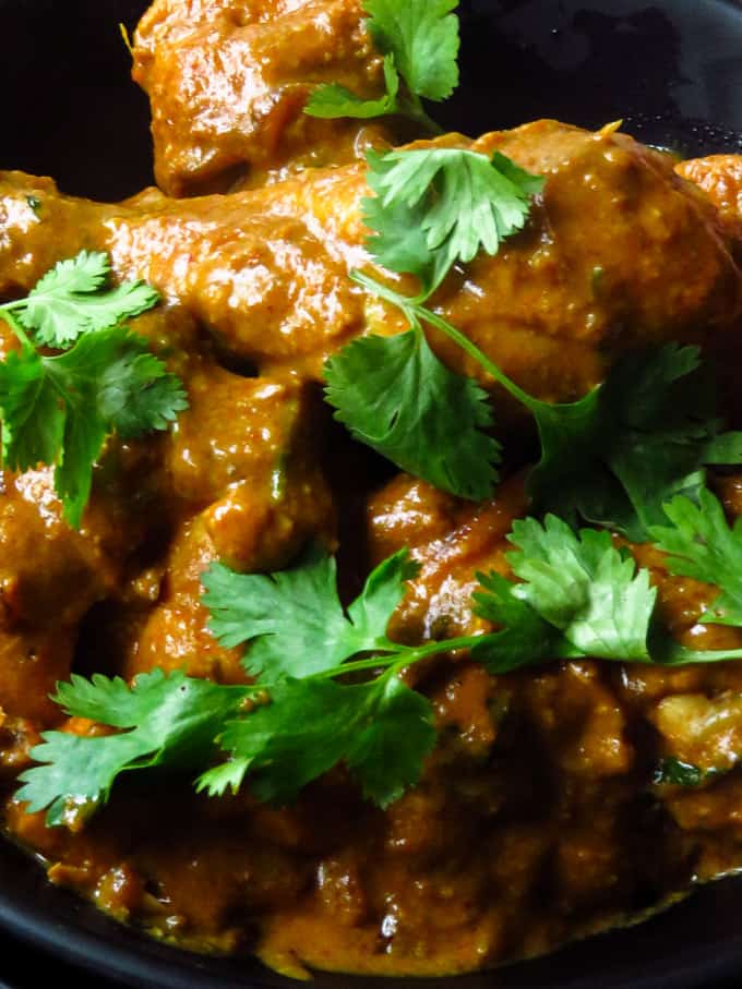 chicken mughlai with a thick curry and garnish with coriander.