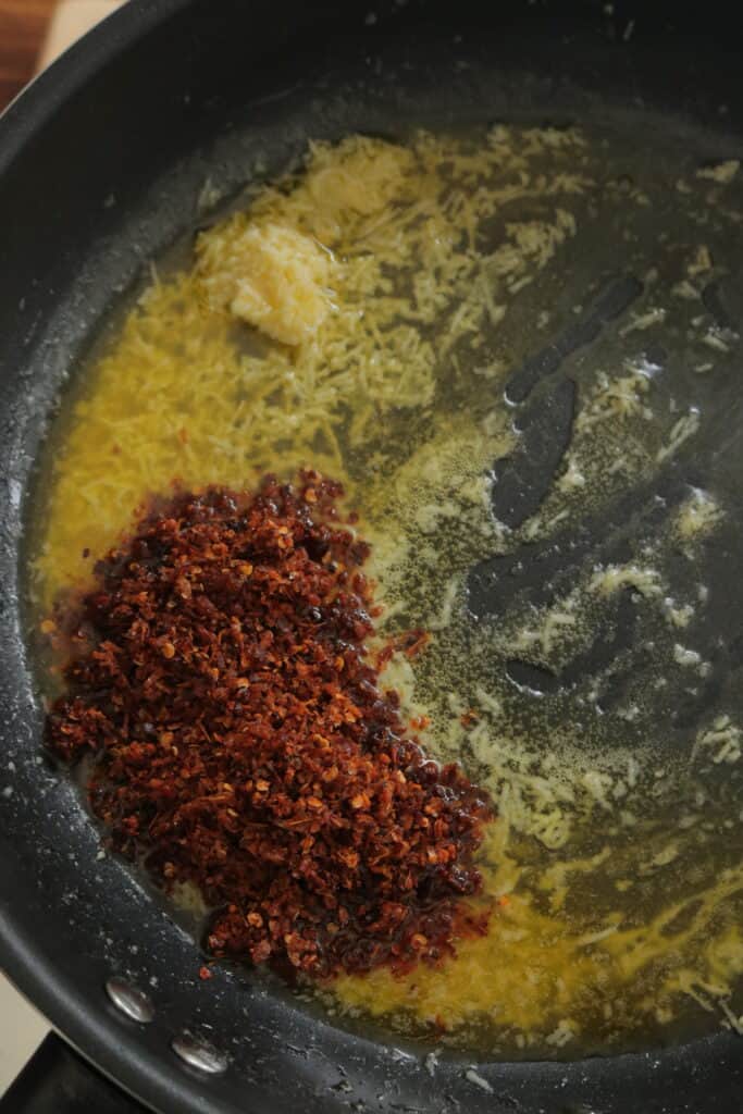 add the chilli paste to the hot garlic butter sauce.