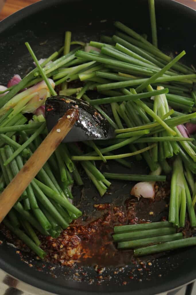 add the spring onions into the hot garlic butter sauce.