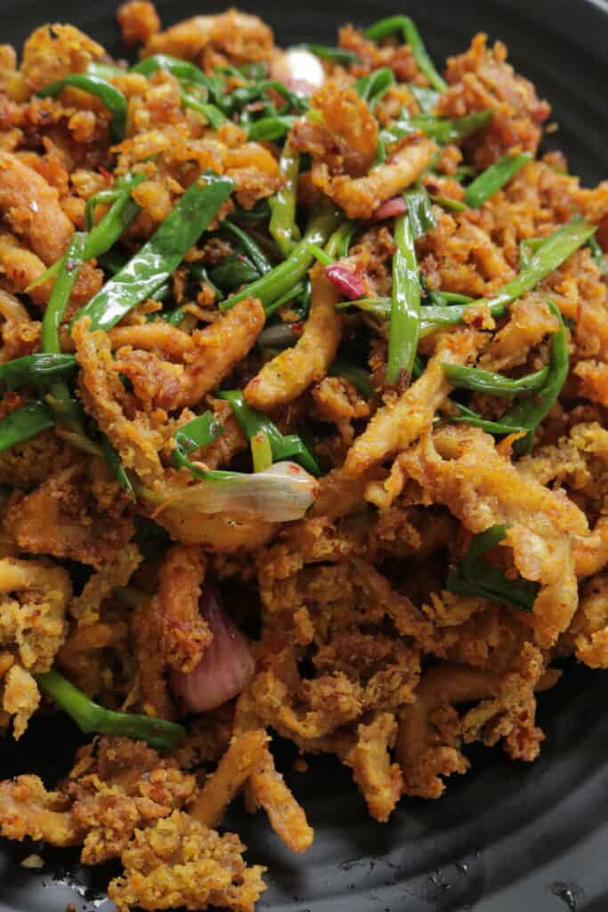 crispy fried mushroom tossed with green onions for the hot butter mushroom fry recipe.