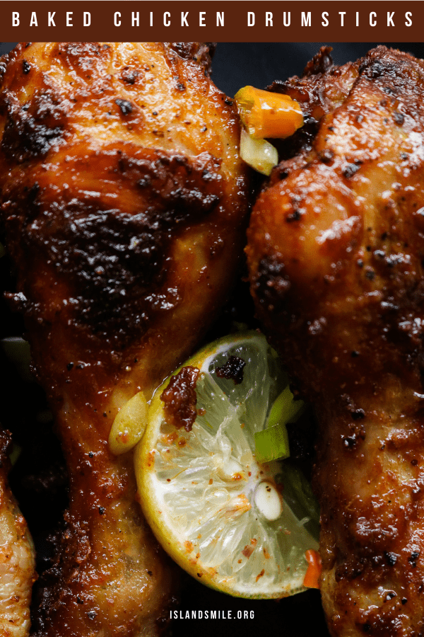 crispy oven baked chicken drumsticks with garnish and slices of lime.