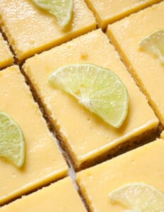 key lime bars with slices of lime on top of it.