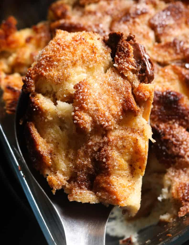 baked and butter pudding with chocolatr and sugar sprinkled on top