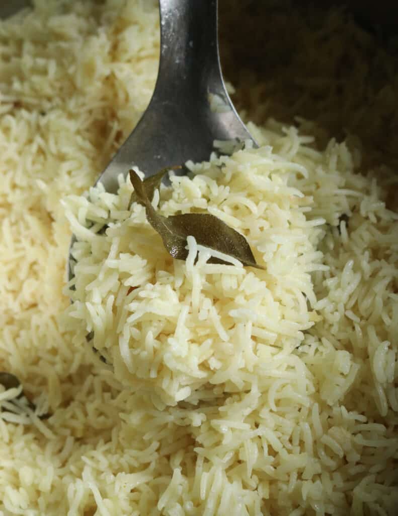 basmati coconut rice scooped with a silver spoon.
