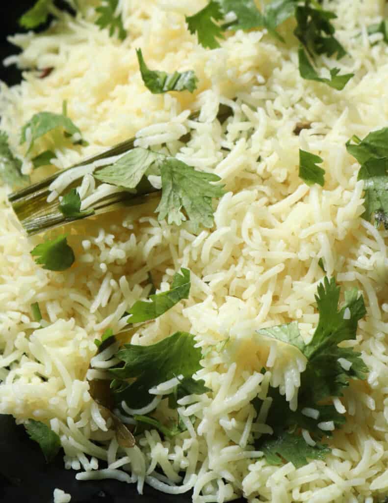 basmati coconut rice cooked and garnished with coriander leaves.