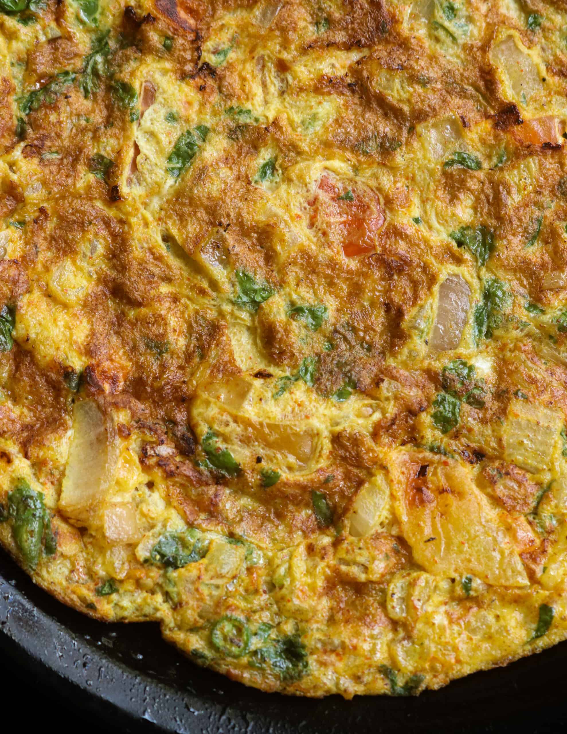 Indian masala omelette with coriander leaves, onions, tomatoes and curry powders.