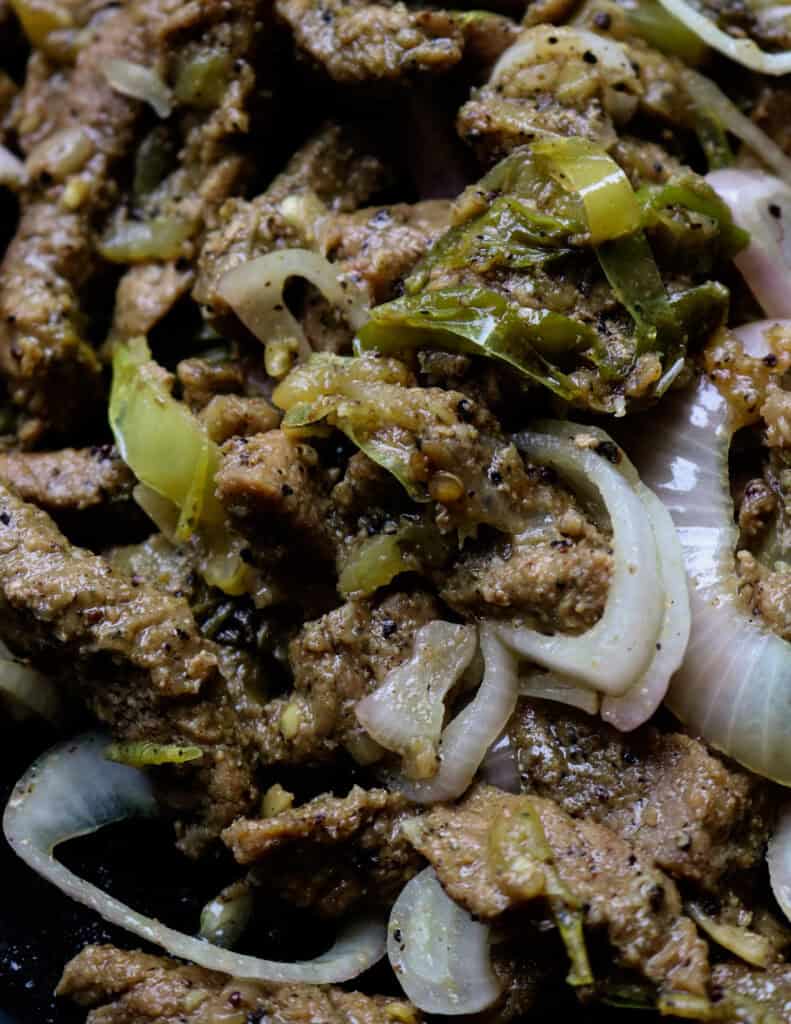 beef bistake tossed in pepper sauce and sliced onions cooked together.