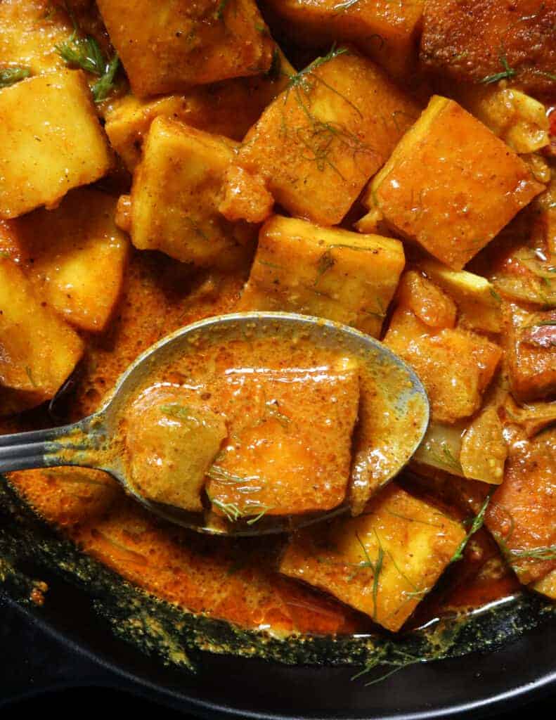 crispy paneer cooked in coconut milk and scooped with a spoon.
