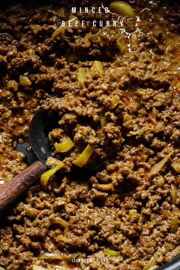 minced beef curry served with a wooden spoon.