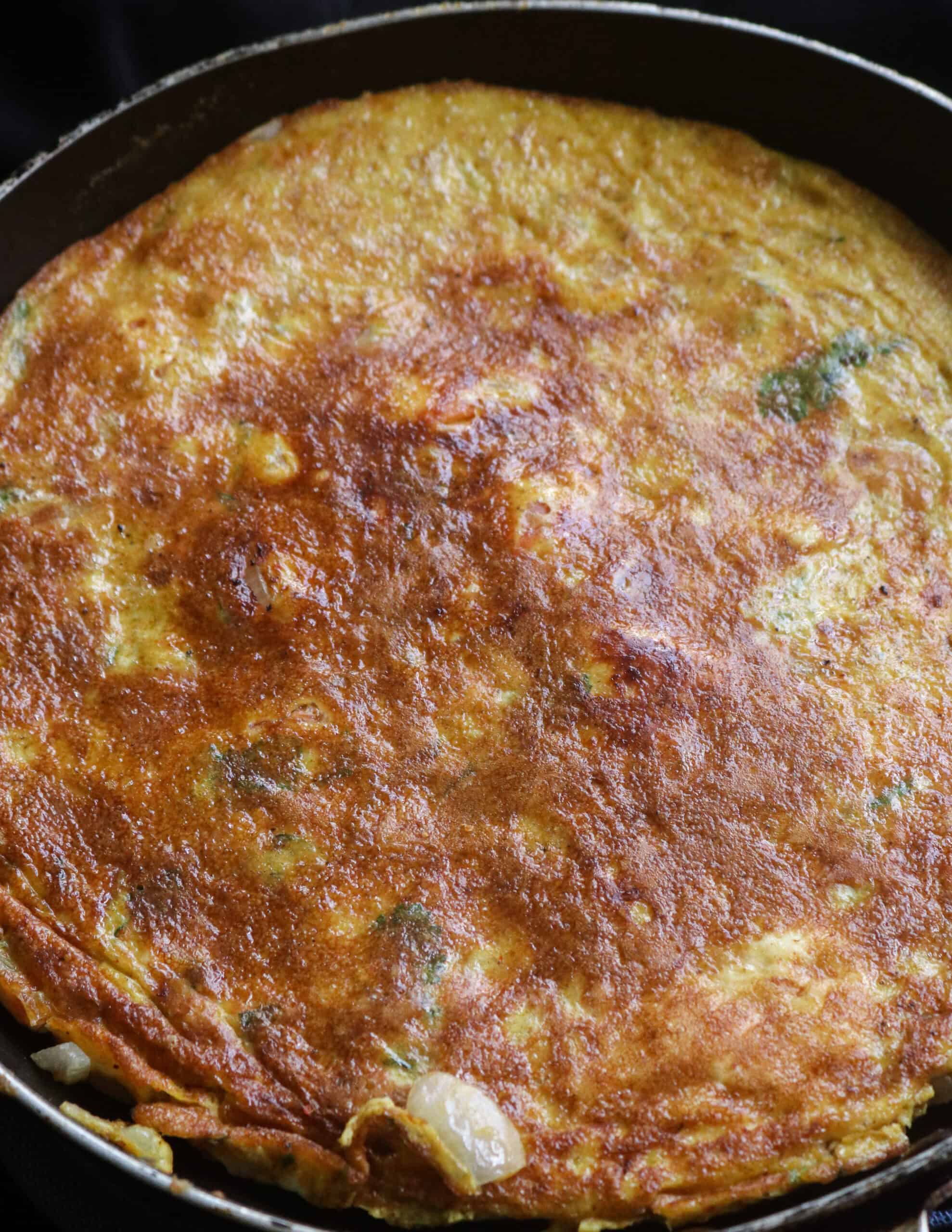 flipping the masala omelette.